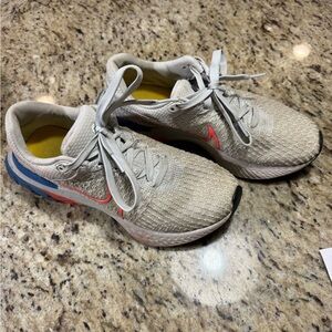 Nike woman’s Light Gray Sneakers with Coral Swoosh and Blue Heel Accents